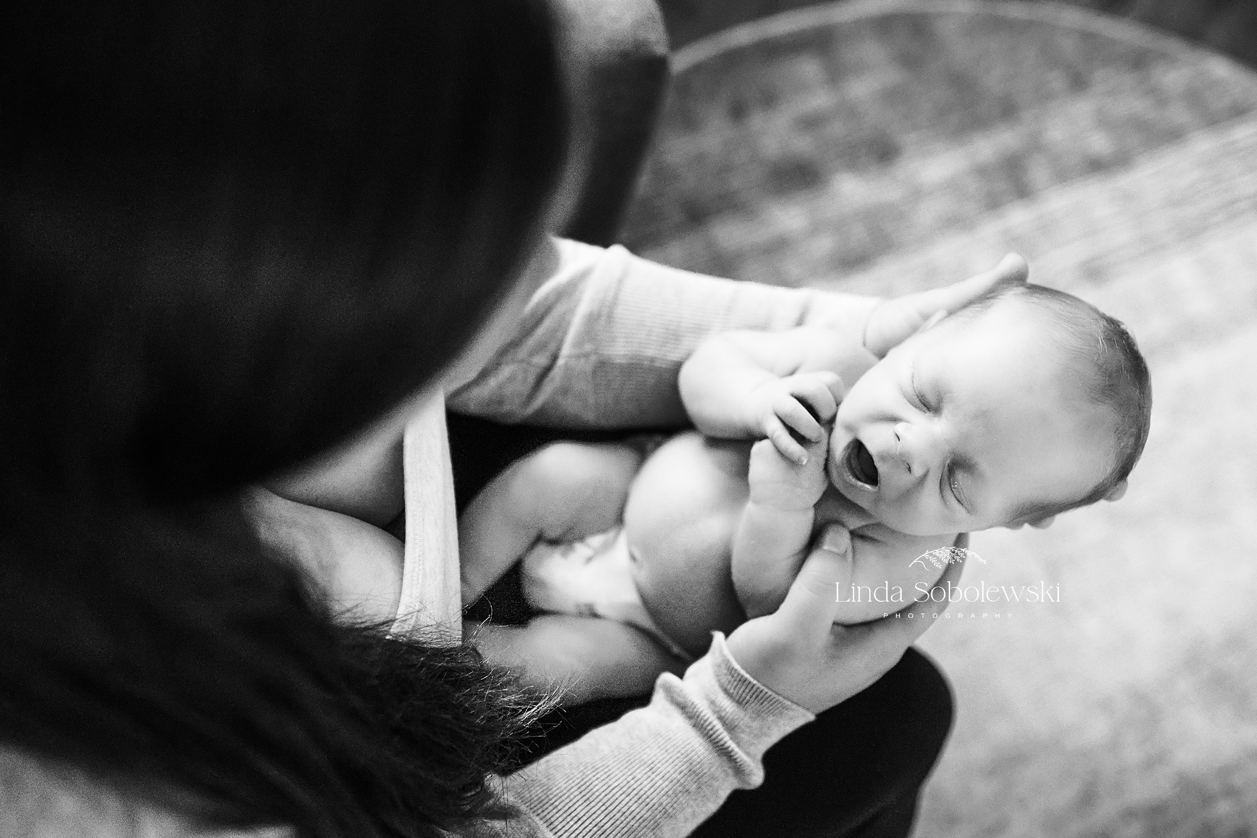 black and white image of baby laying in mother's lap, Madison CT photographer