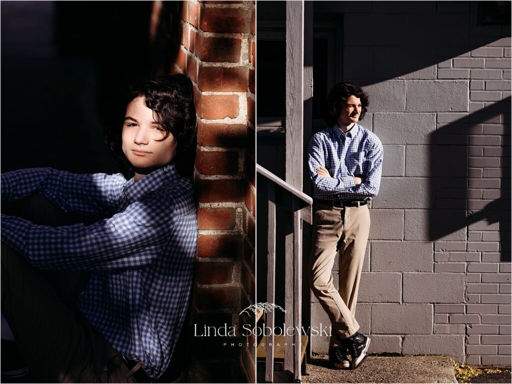 high school senior man in blue shirt and tan pants leaning against a wall and sitting on steps, Old Saybrook and Westbrook CT photographer