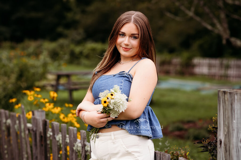 girl in brown hair holding flowersat a park, Madison CT photographer