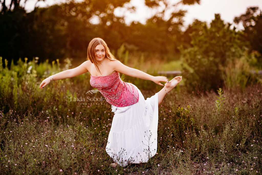 girl in white skirt holding a dance pose, Hammonasset Beach Senior Session, CT senior photographer