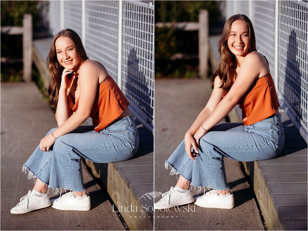 girl sitting against a fence at the beach, Gymnastics senior session