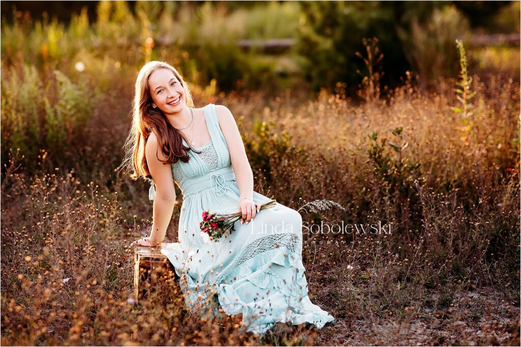 girl in blue dress holding flowers, Gymnastics Senior Photo session