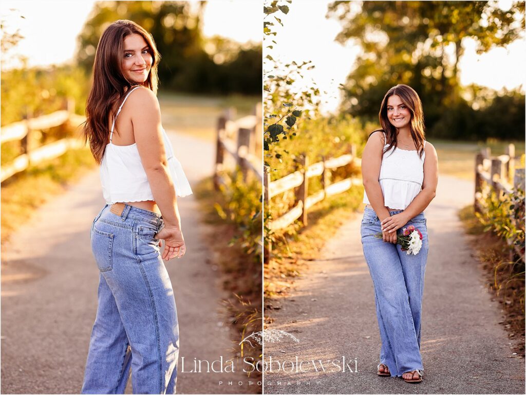 girl in blue jeans and white top standing in a aidewalk, CT senior photogapher