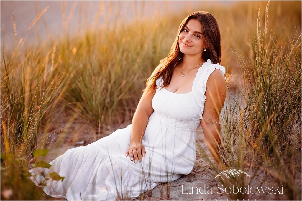 girl in white dress sitting in golden beach grasses, High School Senior session at the beach