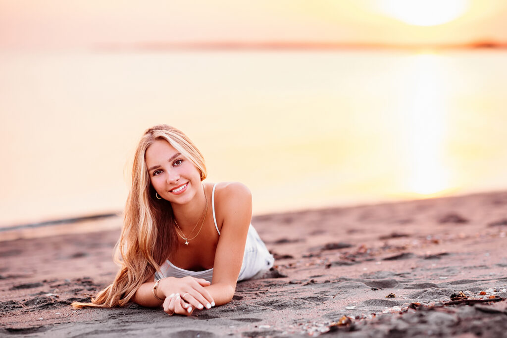 teenage girl laying at the beach for her CT Senior Beach Session, Madison CT Senior photographer