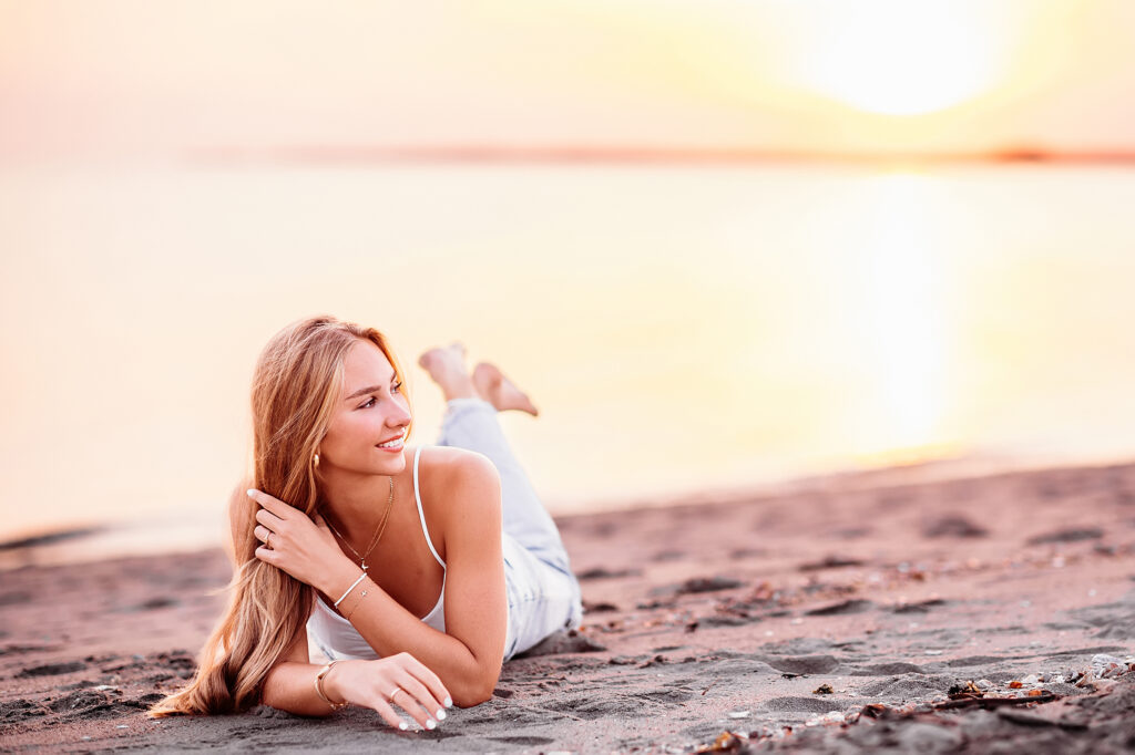 teenage girl laying at the beach for her CT Senior Beach Session, Madison CT Senior photographer