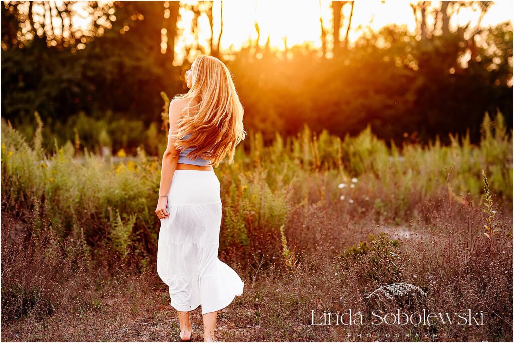 girl in whit skirt spinning around, Madison CT Senior photographer