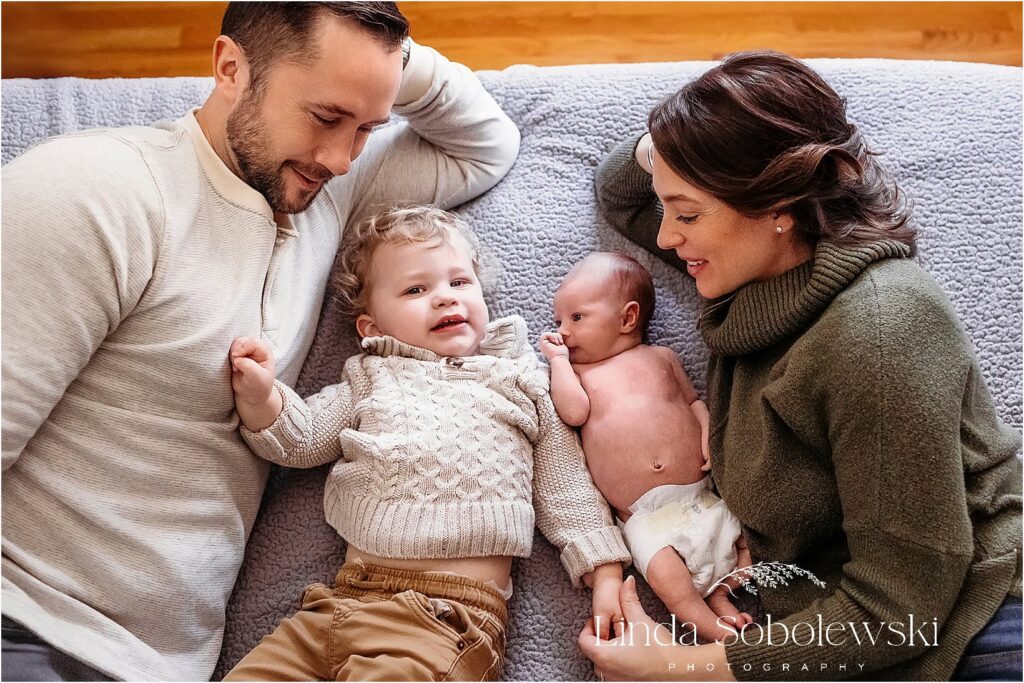 family of four in bed together. Newborn Photography session in Branford CT