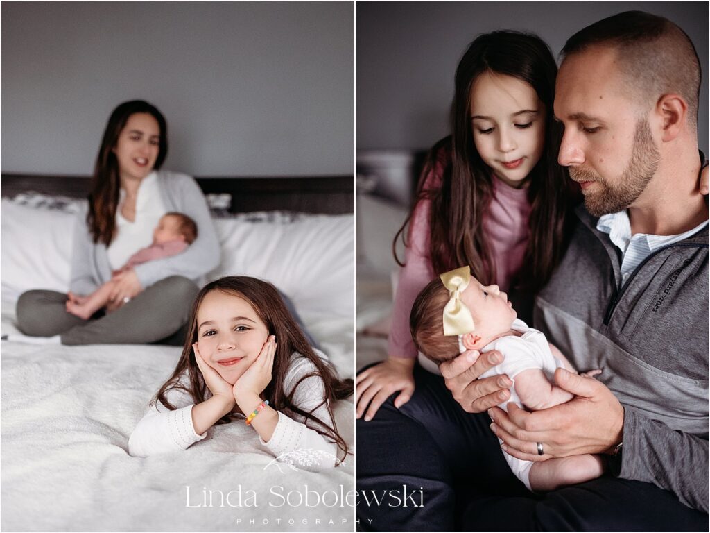 A dad and big sister look lovingly at the newborn baby, capturing a sweet family moment in this Connecticut newborn session.