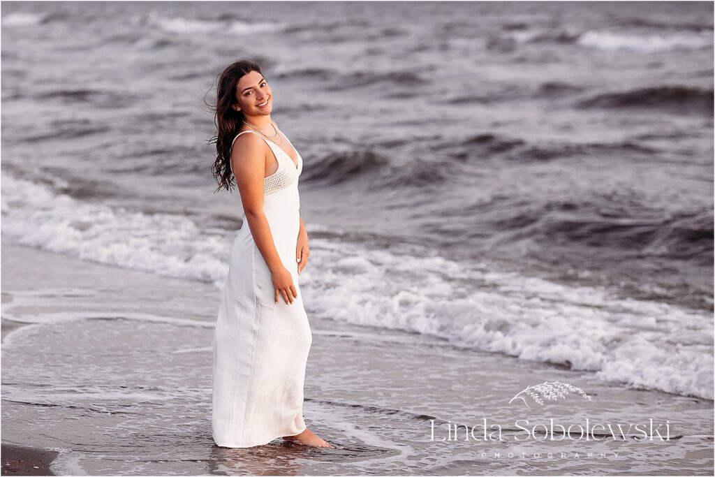 Senior Photography Madison, CT – Stunning senior portraits on the beach with waves and ocean breeze, creating a relaxed and elegant look.