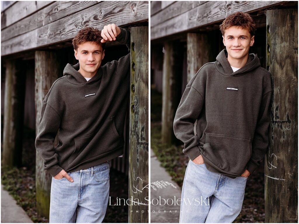 High school senior boy portraits featuring a laid back senior in an all black hoodie at a local Connecticut park, Connecticut shoreline