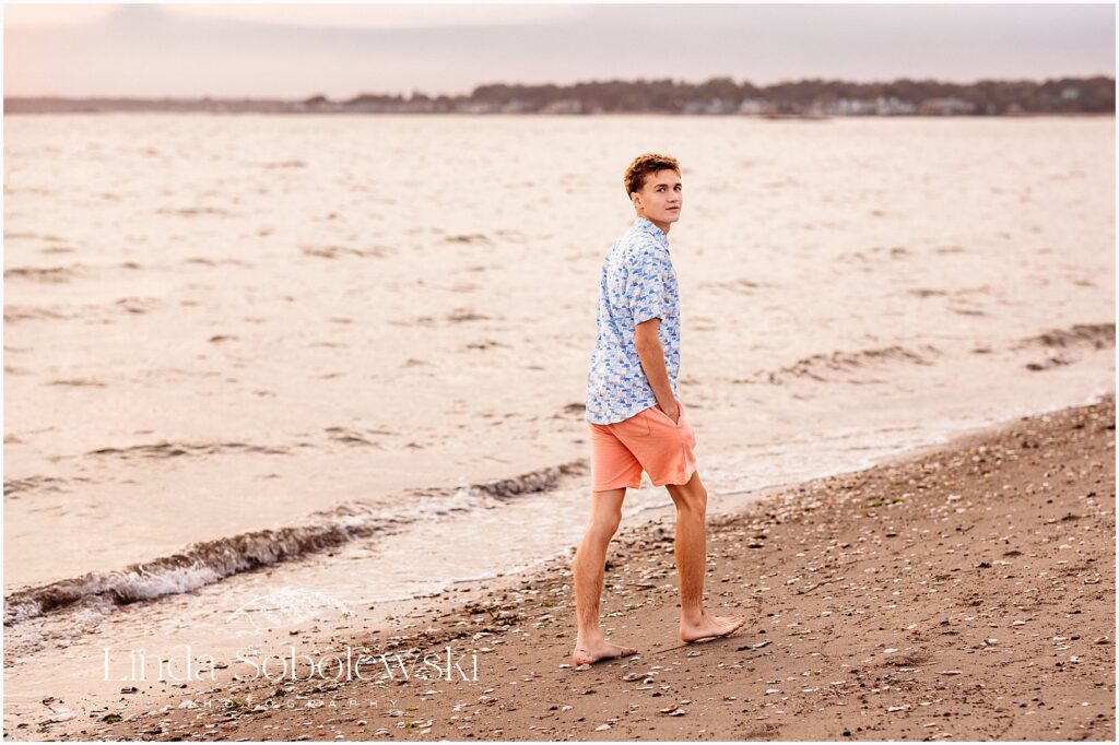 High school senior boy portraits featuring a laid back beach look with soft coastal light, Connecticut shoreline