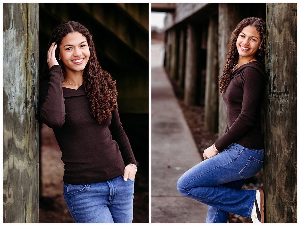 High school senior leaning against weathered dock posts, CT senior photographer Linda Sobolewski