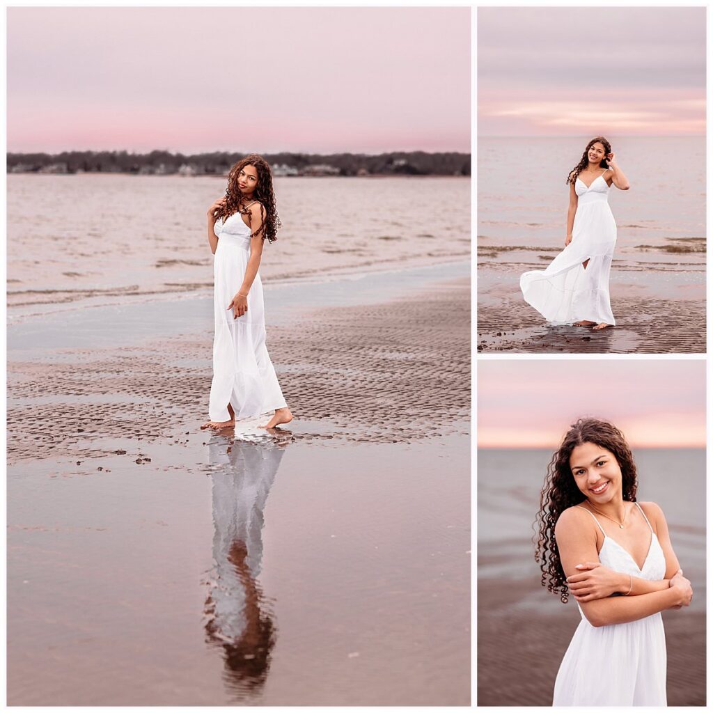 Senior in white dress with fabric flowing in the ocean breeze at sunset