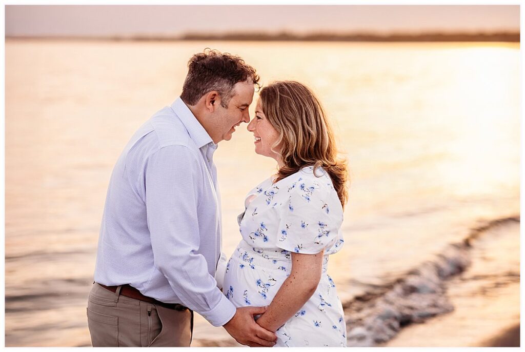 expectant couple on the beach during golden hour, CT shoreline maternity and newborn photographer