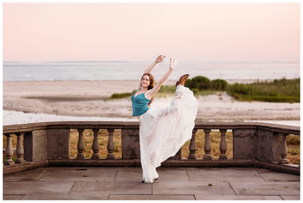 Dancer performing a graceful pose in a flowing white skirt overlooking the beach at Harkness Memorial State Park in Waterford, Connecticut.