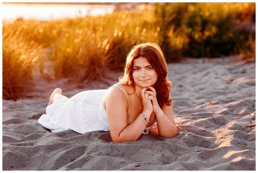 Lily wearing a white sundress for her Connecticut beach senior pictures.